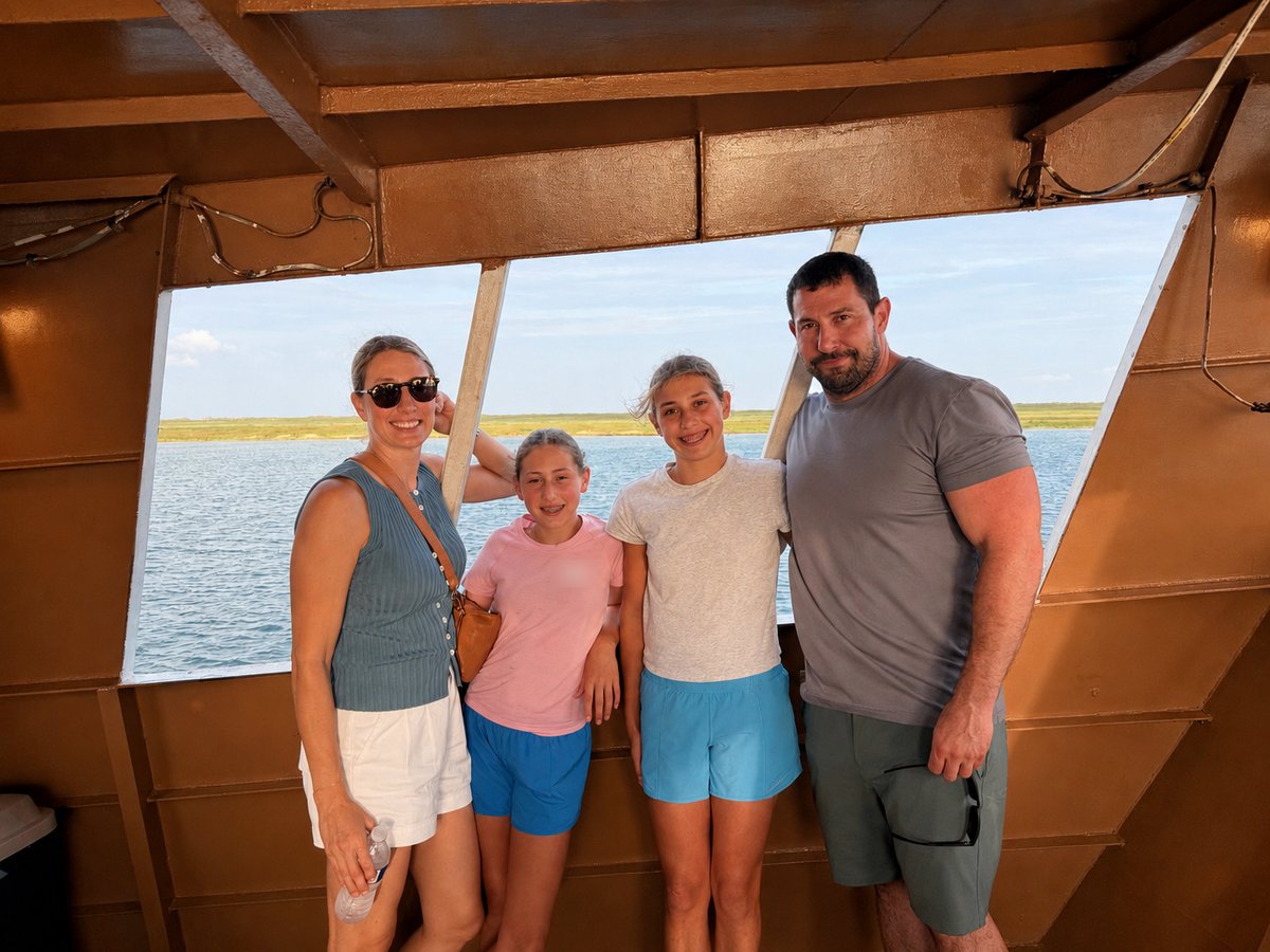 Matthew Laird with his wife and two of their daughters on a boat